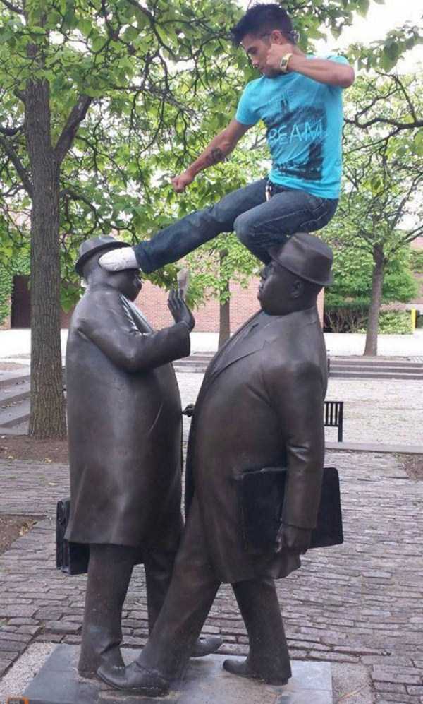 people having fun with statues 41