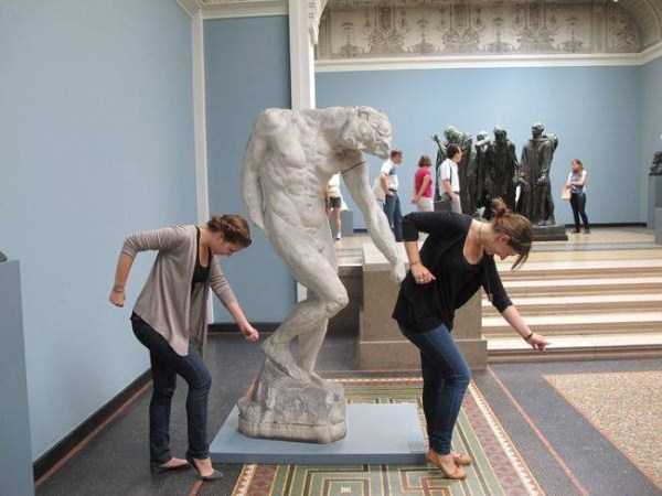 people having fun with statues 59
